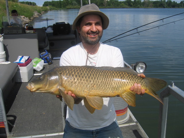 Lawrence on the boat holding a Carp