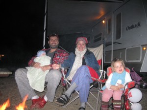 Photo of Lawrence and his family around the camp fire