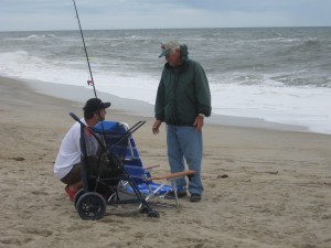 Lawrence setting up his surf fishing gear with the assistance of a fellow surf fisher