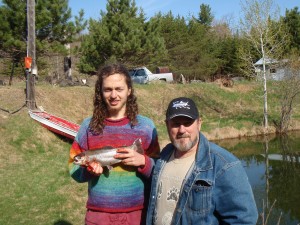 Photo of Walter with Nico holding a 16” Rainbow Trout